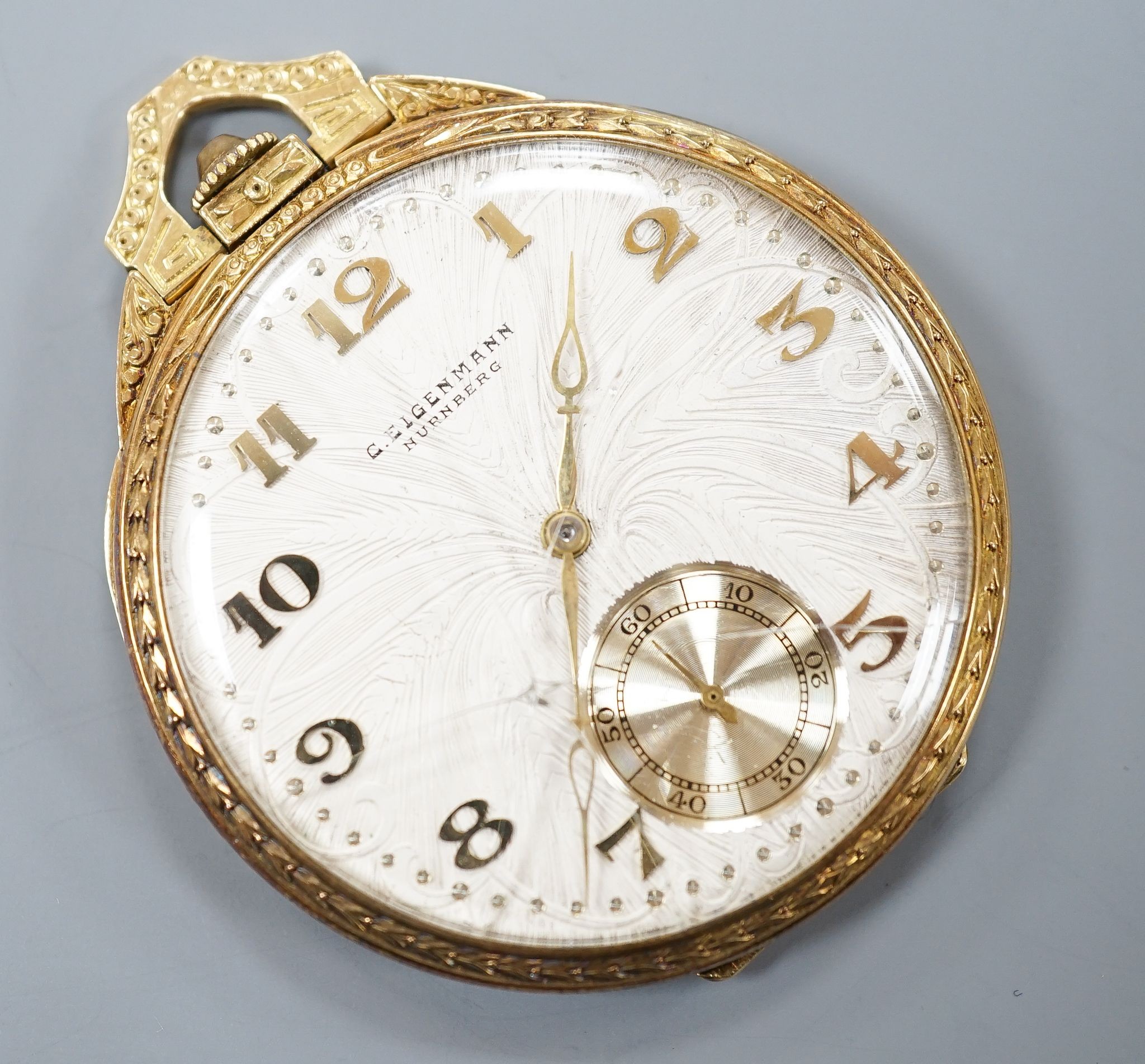 A continental engine turned 750 yellow metal open face dress pocket watch, retailed by Eigenmann, Nuremburg